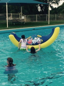 Swimmers play with Sammie Sea Slug